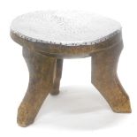 A tribal art African stool, with hammered aluminum top, possibly Ashanti, 36cm wide.