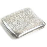 A George V silver cigarette case, profusely decorated with scrolls etc., and a monogrammed cartouche
