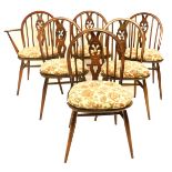 A set of six Ercol beech and elm Windsor chairs, each with a pierced splat, a solid seat on turned l