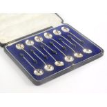 A set of twelve George V silver coffee bean spoons, with shaped bowls, Birmingham 1926, boxed.