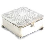 A George V silver jewellery or trinket box, of square form, the top with a shaped edge and a circula
