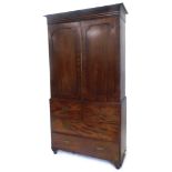 A 19thC figured mahogany clothes press, the top with a moulded cornice above two arched doors enclos
