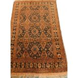 A Balouch type rug, with a design of medallions, in rust coloured medallions on a navy ground with m