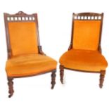 Two similar late 19thC walnut ladies or nursing chairs, each with an orange upholstered padded back