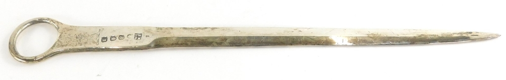 A George III silver letter opener, of plain form, with engraved crest, London 1770, 1¾oz, 23cm long.