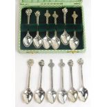A collection of silver coffee spoons, the handles of differing designs to include Celtic cross, ship