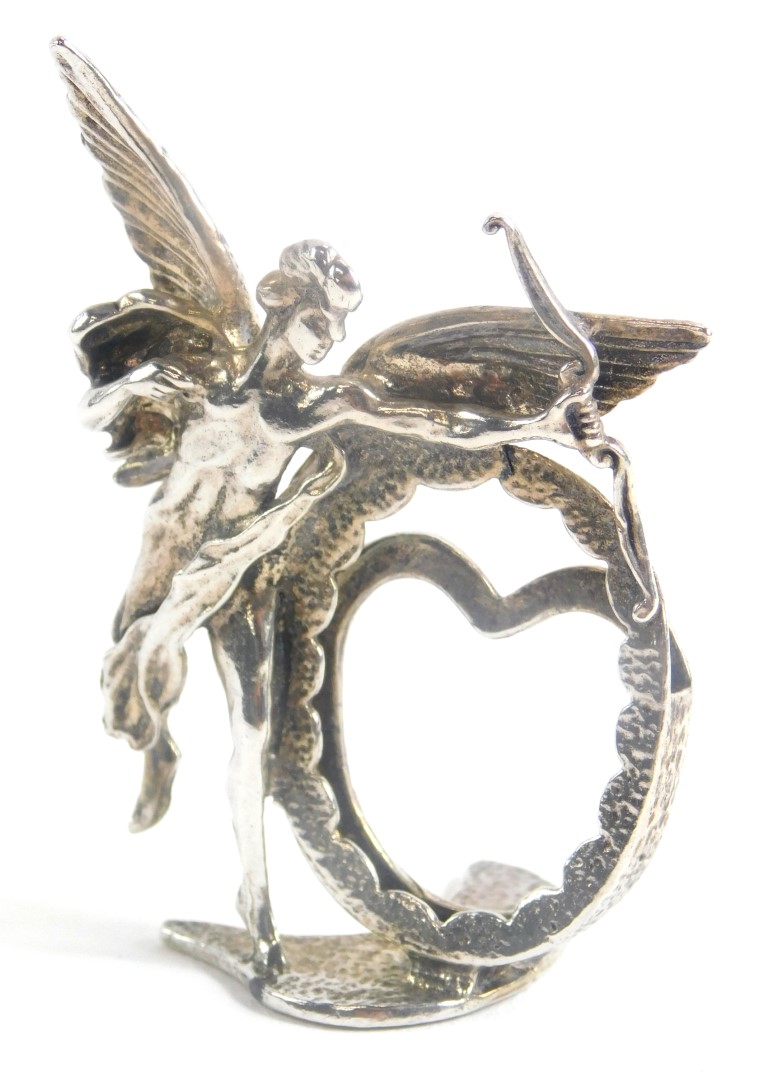 An Elizabeth II miniature photograph frame, shaped as the figure of Cupid moulded around a vacant fr