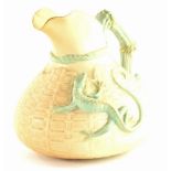 A Royal Worcester porcelain ewer, decorated with a lizard in green on a blush ivory ground, printed