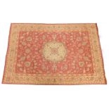 A Laura Ashley Belgian cotton rug, on a red ground.