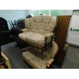 A pair of oak framed two seater sofas, in floral decorated fabric, and a folding bed.