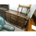 An oak sideboard, the carved panel doors in Gothic style, 90cm high, 140cm wide, 56cm deep.