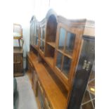 Two similar oak display cabinets.