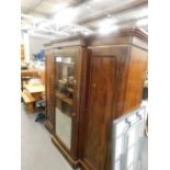 A Victorian figured mahogany triple breakfront wardrobe, with a moulded cornice above a mirrored doo