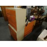 Three mid 20thC bedside chests, of similar design with orange painted drawers.