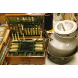 A cased canteen of cutlery, Derby and Bee Co-op milk churn and a large pan.