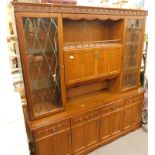 An oak Morris Furniture Company dresser, the top with two leaded glazed doors, with a central flap s