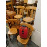 A rectangular stained pine coffee table, four kitchen chairs and Miele vacuum cleaner.