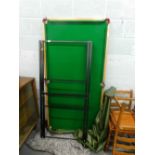A snooker table and stand with folding legs and cover.