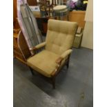 An oak framed armchair, with upholstered button back, seat and arms. The upholstery in this lot does