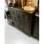 A dark Ercol cabinet, with two hinged doors above a fall, 94cm high, 86cm wide, 53cm deep, (AF).