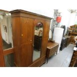 An early 20thC mahogany wardrobe and dressing table, the wardrobe with a mirrored central door, inla