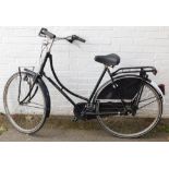 A Holland Classic President lady's bicycle, retro style with black frame, basket to the front.
