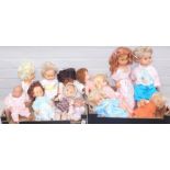 A quantity of plastic dolls, each with main plastic body one with material body in various dress, un