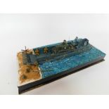 A part scratch built model of a US WWII landing craft, with a Sherman tank, soldiers and other figur