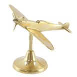 An aeronautical brass desk stand, modelled as a Spitfire, 16.5cm wide.