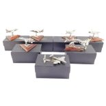 Eight Royal Hampshire Art Foundry models of fighter aircraft, raised on wooden stands, boxed.