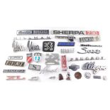 Various metal and plastic car emblems, including Ford Cortina, Viva, Sherpa, Peugeot and Lancia. (a
