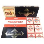 Two Waddingtons Monopoly 50th Anniversary Edition games, a wooden cased Monopoly, board damaged, and