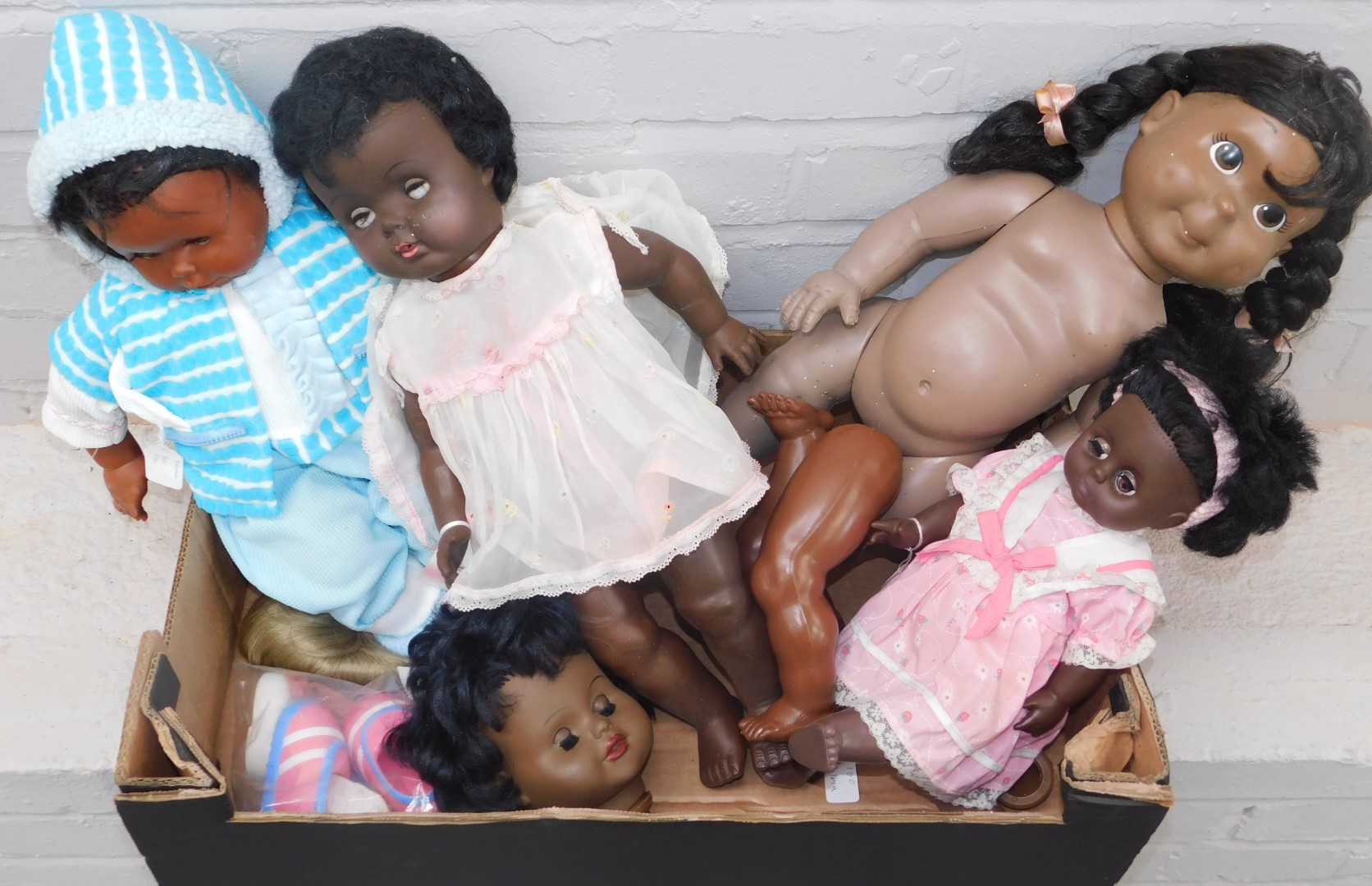 A group of dolls, each plastic, some with dress. (4)