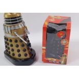 A Product Enterprise battery operated Gold Supreme Dalek, together with a Dr Who Dalek money bank. (