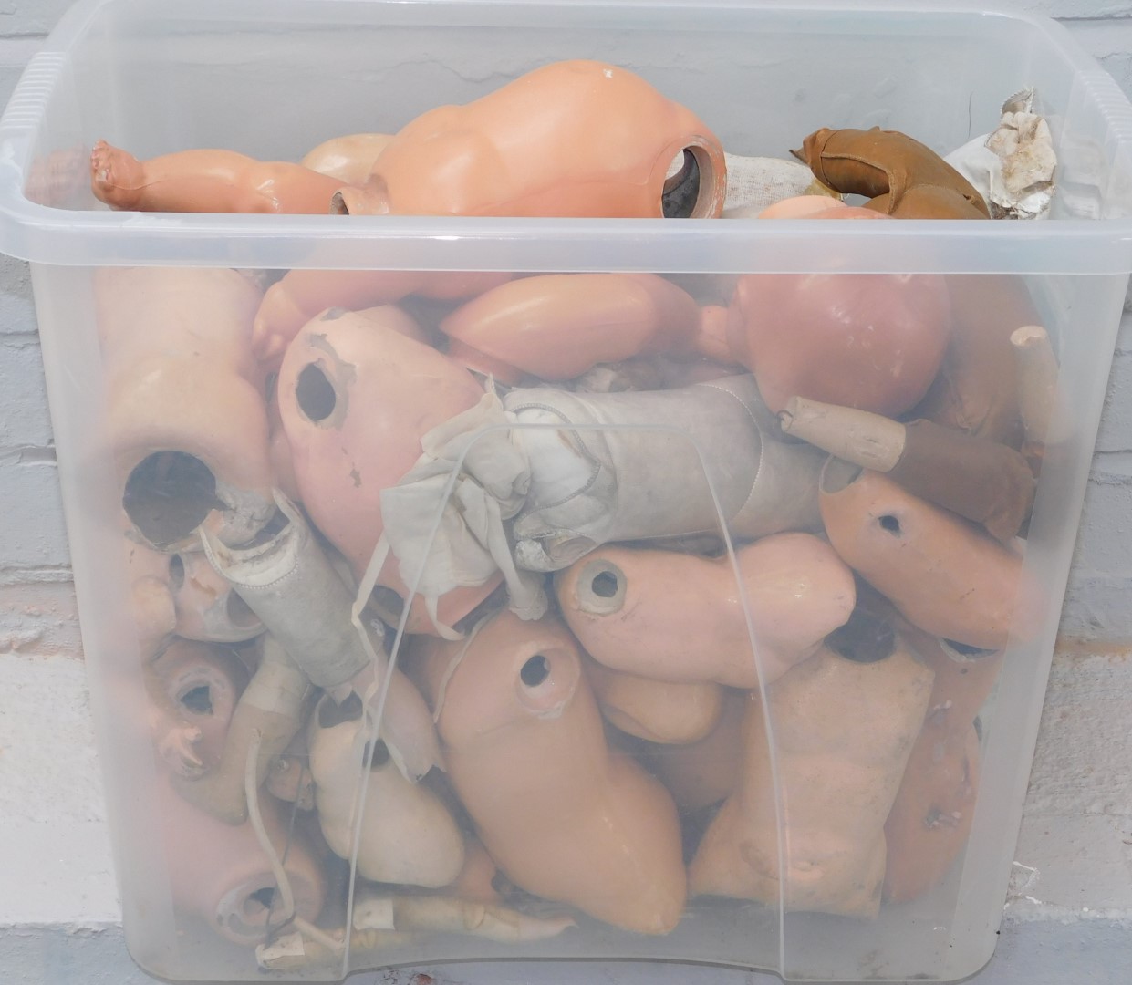 A group of bisque papier mache and material doll parts. (1 box)