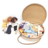 Two Sindy dolls, a further doll, and various clothing and accessories, in a vanity case.