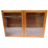 A mahogany two door collector's cabinet, with four glass shelves, 65cm high, 95cm wide, 16.5cm deep.