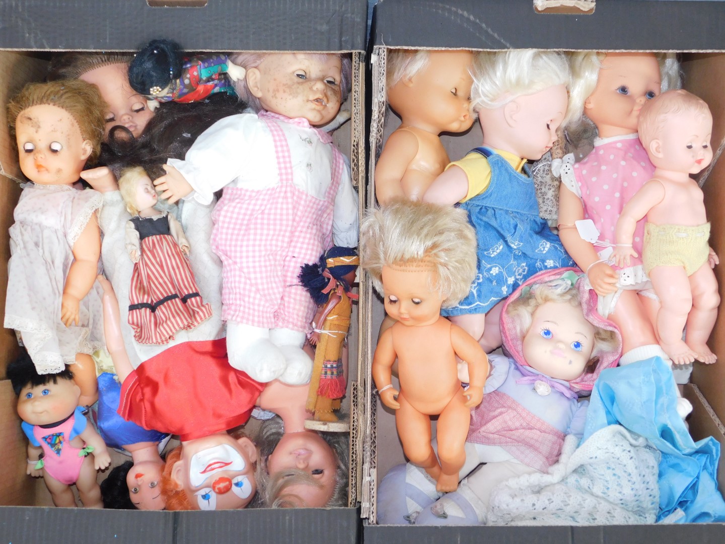 A group of dolls and figures, a plastic model of a clown, a Snow White type figures, various other d