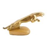 A brass desk stand, modelled as a Jaguar car mascot, 18.5cm wide.