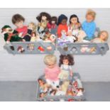 A group of assorted dolls, to include large plastic dolls, miniature dolls, various dolls clothing,