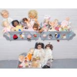 A group of dolls, to include mainly plastic headed examples, some small porcelain figures, a model A