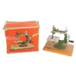 A Grain early 20thC toy sewing machine, boxed.