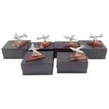 Six Royal Hampshire Art Foundry models of fighter and bomber aircraft, raised on wooden stands, bo