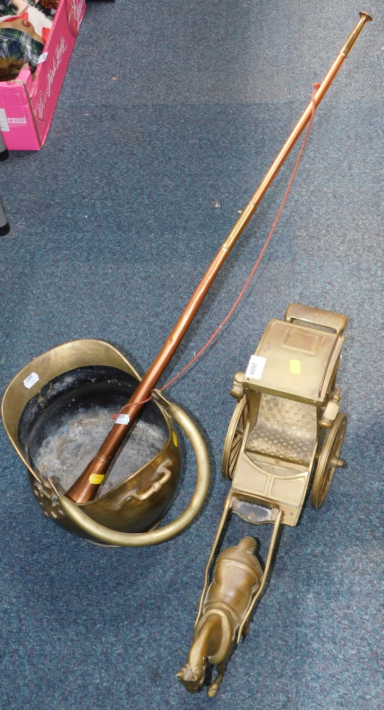 A brass horse and carriage, together with a brass coal scuttle, and a copper coaching horn. (3)