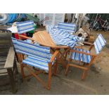 A teak folding garden table, four directors style chairs and a matching parasol. (6)
