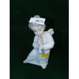 A Lladro figure of a cherub playing flute. (AF)