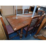 A Spanish pine dining table, with turned and splayed legs, with central iron stretcher, together wit