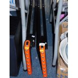 A pair of folding stands with rollers.