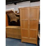 An oak and beech part bedroom suite, comprising two door wardrobe and a matching chest of six drawer