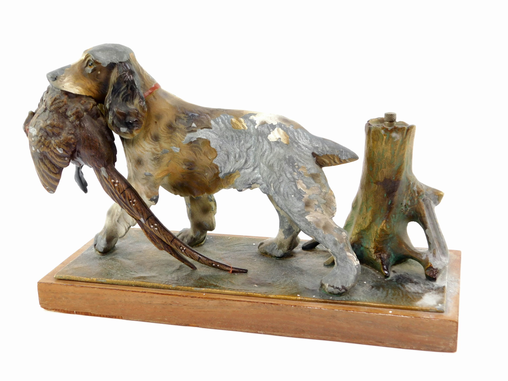 A Continental cold painted spelter stike lighter, modeled in the form of a spaniel with a pheasant,